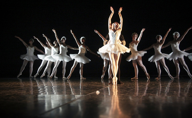 Photographie d'un ballet de Chelsea avec un couple de danseur émérgeant de l'ombre de la scène.